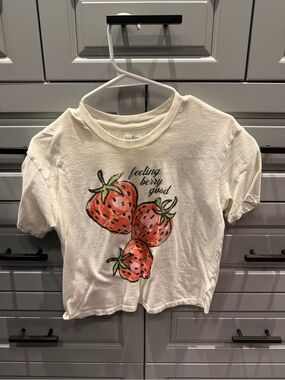 Rebellious One Cream Tee with Red Strawberry Graphic